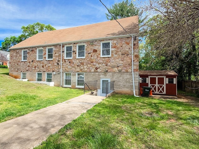 1203 Windsor Ln, Staunton, VA 24401 - back of property featuring a storage unit, an outdoor structure, stone siding, and a shingled roof