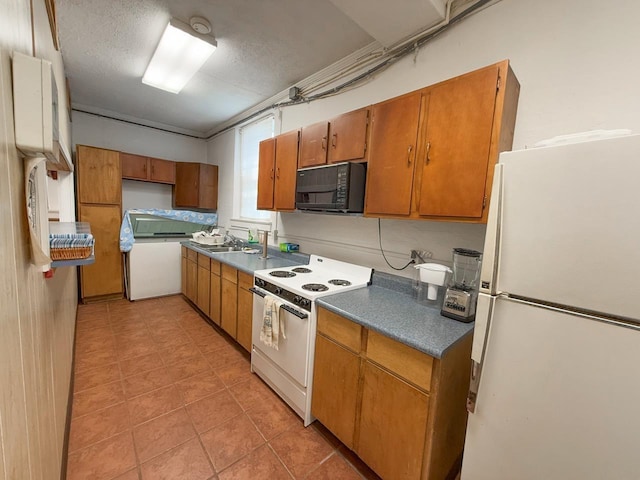 1203 Windsor Ln, Staunton, VA 24401 - kitchen with white appliances, dark countertops, brown cabinets, a sink, and light tile patterned floors