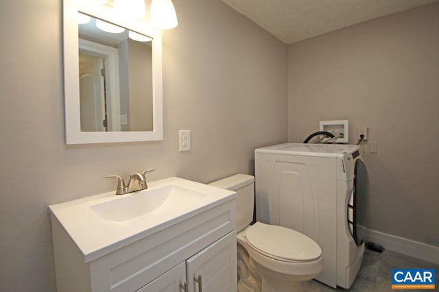 309 Port Republic Rd, Waynesboro, VA 22980 - bathroom featuring washer / clothes dryer, toilet, vanity, and baseboards
