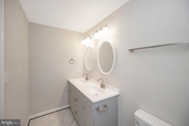 bathroom featuring vanity and toilet