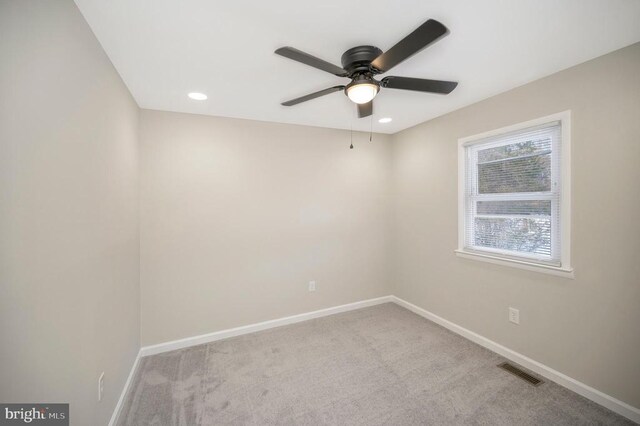 spare room featuring ceiling fan and light colored carpet