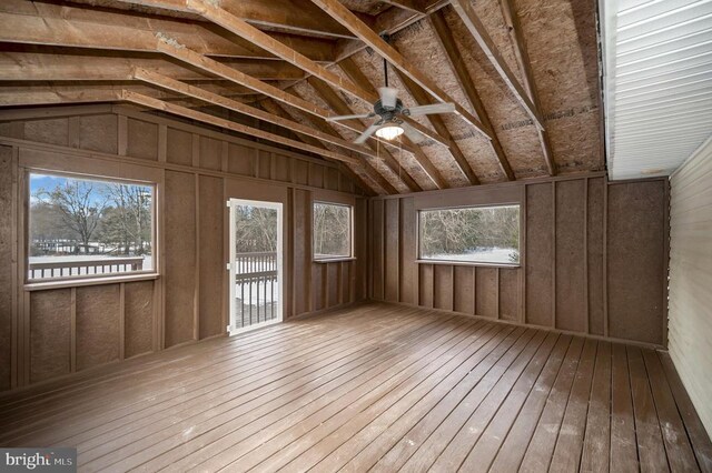 unfurnished sunroom featuring ceiling fan and vaulted ceiling