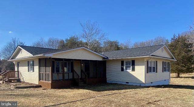 view of front of home with a sunroom