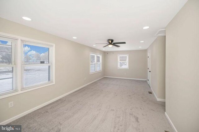 unfurnished room featuring ceiling fan and light colored carpet