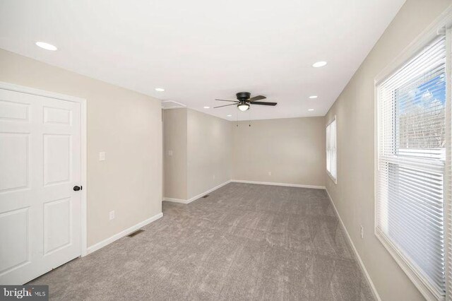 empty room featuring carpet floors and ceiling fan