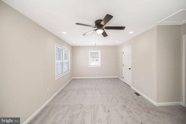 unfurnished room featuring light carpet and ceiling fan