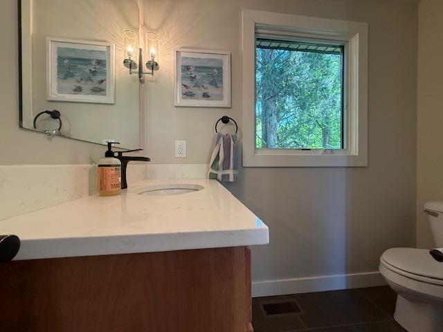 1201 Lakeshore Dr S, Louisa, VA 23093 - half bath featuring toilet, vanity, tile patterned flooring, and baseboards