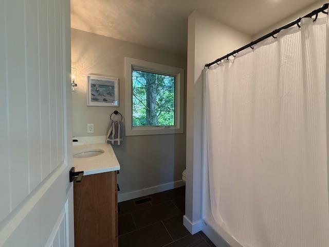 1201 Lakeshore Dr S, Louisa, VA 23093 - full bath featuring vanity, tile patterned flooring, baseboards, toilet, and curtained shower