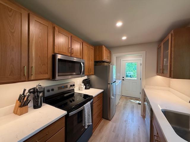 1201 Lakeshore Dr S, Louisa, VA 23093 - kitchen featuring stainless steel appliances, a sink, light wood-style floors, brown cabinets, and light countertops