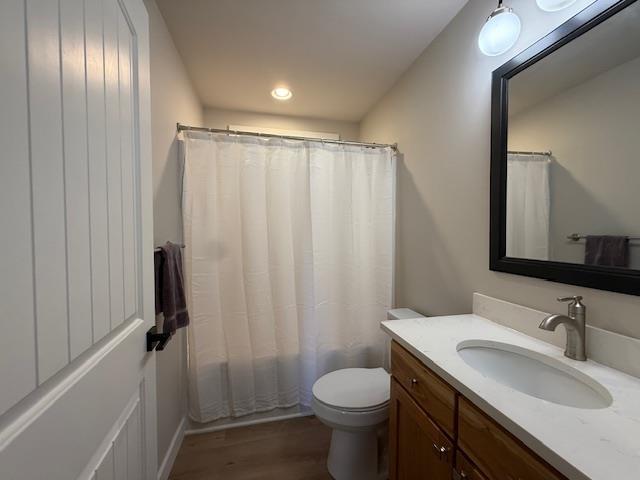 1201 Lakeshore Dr S, Louisa, VA 23093 - bathroom with vanity, toilet, wood finished floors, recessed lighting, and shower / bathtub combination with curtain