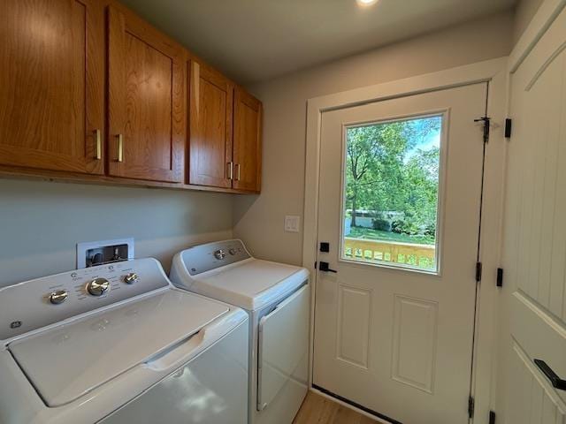 1201 Lakeshore Dr S, Louisa, VA 23093 - laundry area featuring cabinet space, separate washer and dryer, and light wood-style floors