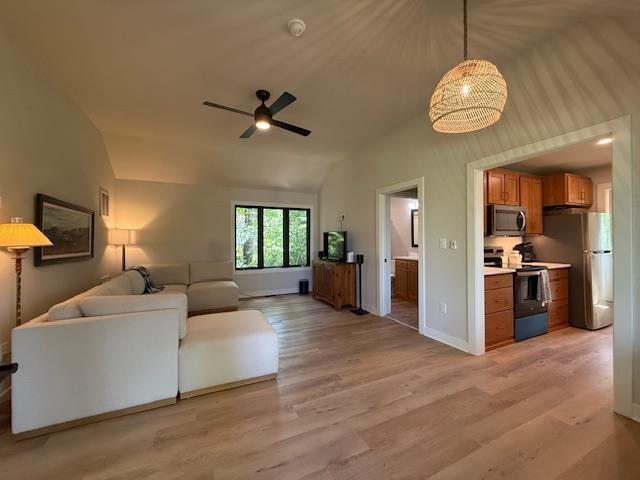 1201 Lakeshore Dr S, Louisa, VA 23093 - living room featuring lofted ceiling, light wood finished floors, ceiling fan, and baseboards