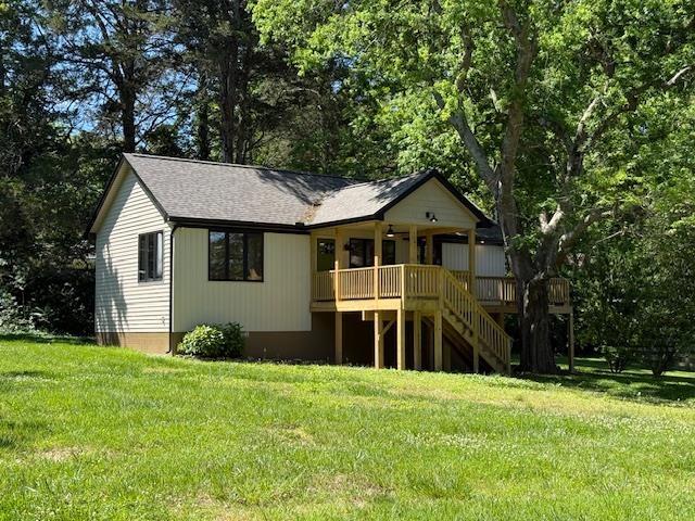 1201 Lakeshore Dr S, Louisa, VA 23093 - back of house with stairs, a lawn, a porch, and a shingled roof