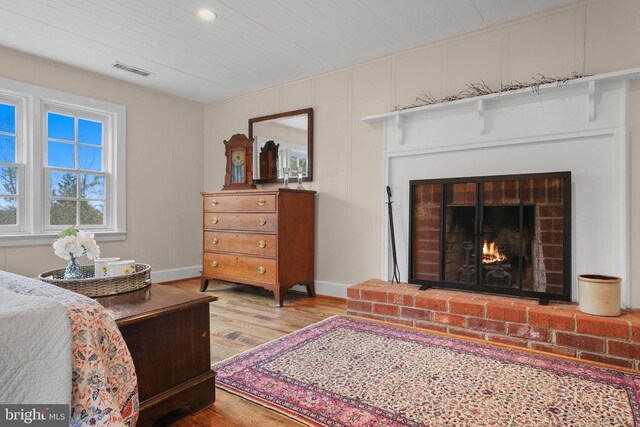 412 Nelmonte Ln, Arrington, VA 22922 - bedroom with wood finished floors, a brick fireplace, baseboards, and wood ceiling