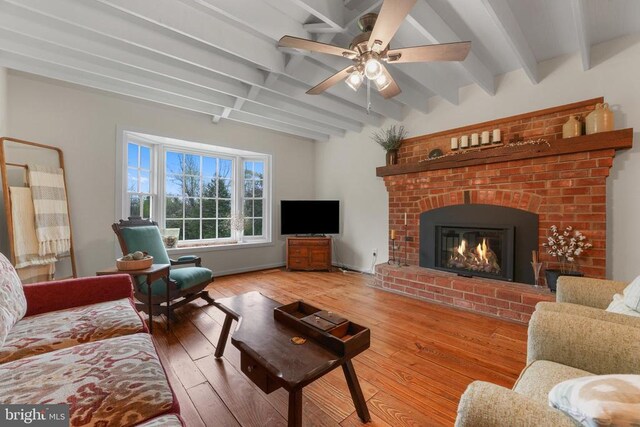 412 Nelmonte Ln, Arrington, VA 22922 - living room with beamed ceiling, a ceiling fan, hardwood / wood-style floors, and a brick fireplace