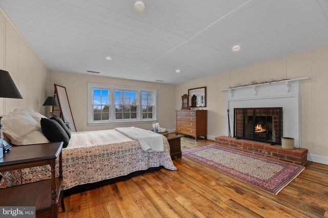 412 Nelmonte Ln, Arrington, VA 22922 - bedroom with hardwood / wood-style floors and a brick fireplace