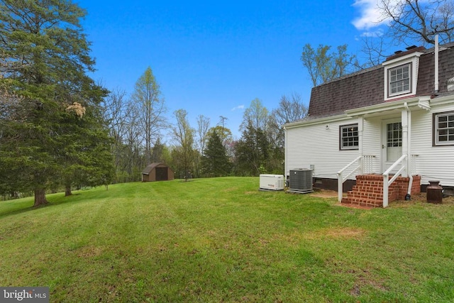 412 Nelmonte Ln, Arrington, VA 22922 - view of green lawn featuring central air condition unit, a storage shed, an outbuilding, and entry steps
