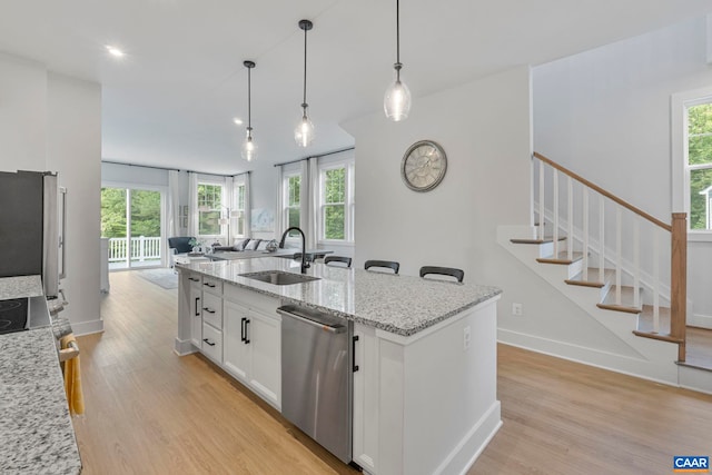 1802 Flora Ln, Charlottesville, VA 22911 - kitchen featuring appliances with stainless steel finishes, light wood-style flooring, white cabinets, open floor plan, and recessed lighting