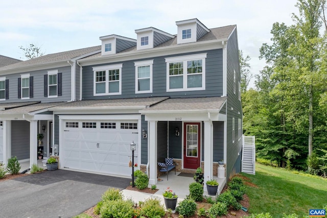 1802 Flora Ln, Charlottesville, VA 22911 - view of front of home with driveway, a front yard, a garage, a porch, and a shingled roof