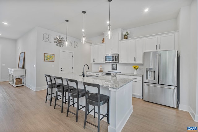 1802 Flora Ln, Charlottesville, VA 22911 - kitchen with appliances with stainless steel finishes, a center island with sink, white cabinetry, and recessed lighting
