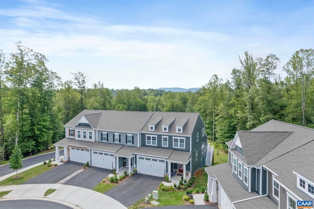 1802 Flora Ln, Charlottesville, VA 22911 - view of front facade featuring driveway, an attached garage, and a wooded view