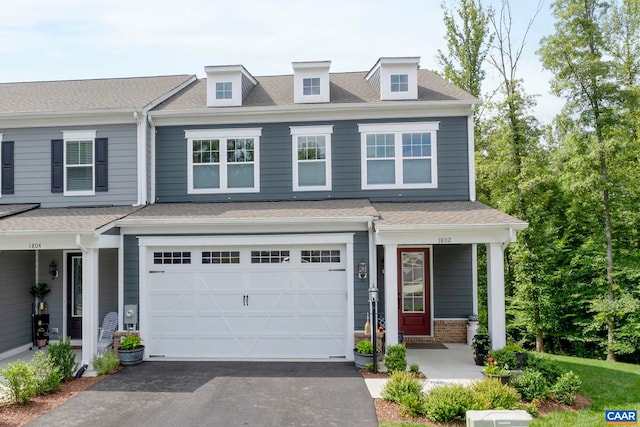 1802 Flora Ln, Charlottesville, VA 22911 - view of property with asphalt driveway, a porch, a garage, and roof with shingles
