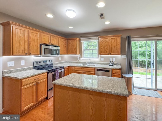 108 Apple Orchard Rd, Louisa, VA 23093 - kitchen featuring stainless steel appliances, light wood-style floors, a kitchen island, recessed lighting, and light stone counters