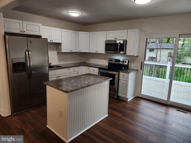 10703 Redbird Ln, Spotsylvania, VA 22553 - kitchen with stainless steel appliances, white cabinets, and dark wood finished floors