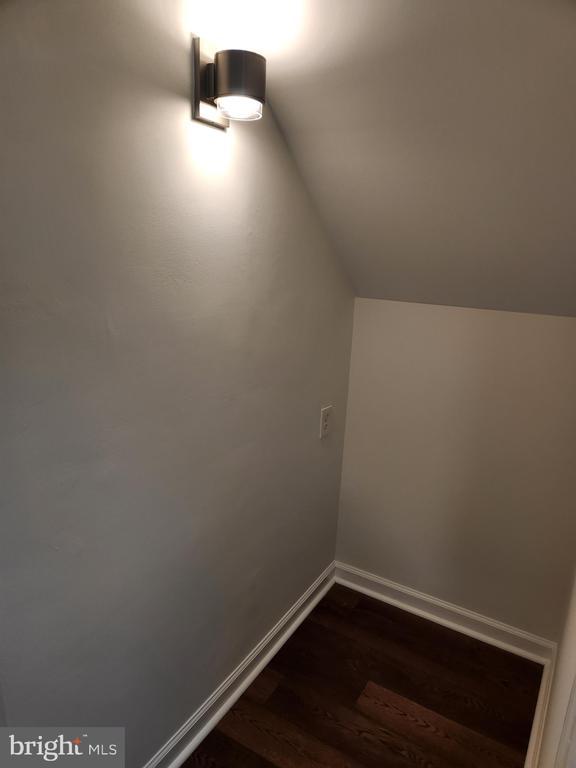 10703 Redbird Ln, Spotsylvania, VA 22553 - additional living space with dark wood-type flooring, lofted ceiling, and baseboards