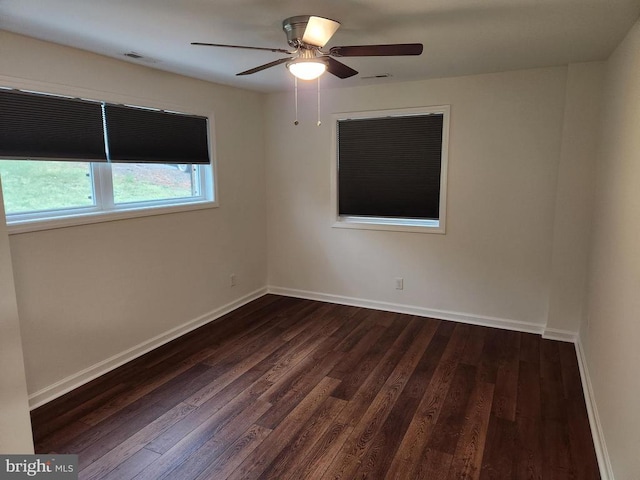 10703 Redbird Ln, Spotsylvania, VA 22553 - unfurnished room with dark wood-style floors, a ceiling fan, and baseboards