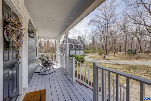 3595 Jumpers Ridge Rd, Keswick, VA 22947 - wooden deck with covered porch, an attached garage, and driveway