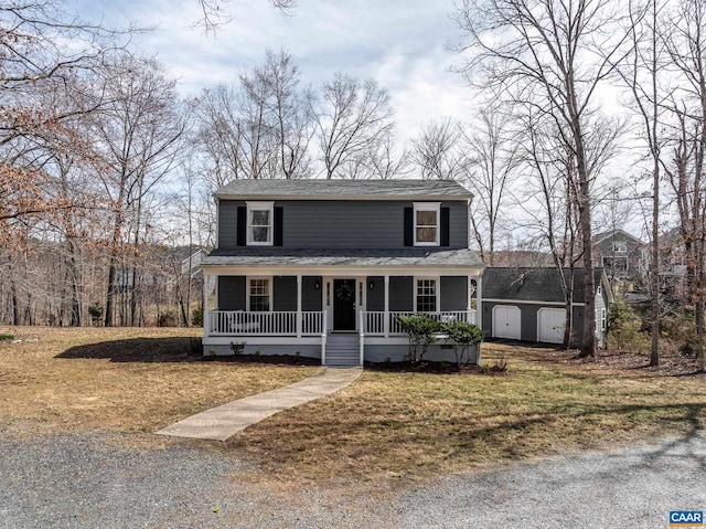 3595 Jumpers Ridge Rd, Keswick, VA 22947 - view of front facade featuring covered porch, a storage unit, a shingled roof, a front lawn, and an outdoor structure