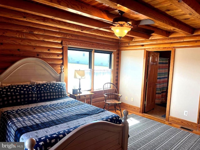 26536 Pennfields Dr, Orange, VA 22960 - bedroom with baseboards, wood finished floors, beamed ceiling, wood ceiling, and rustic walls