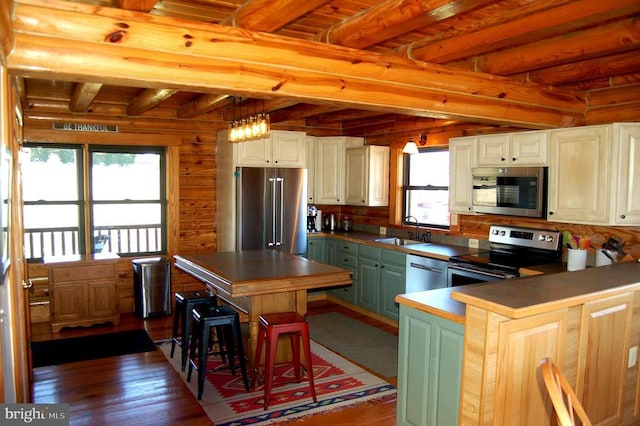 26536 Pennfields Dr, Orange, VA 22960 - kitchen featuring appliances with stainless steel finishes, a sink, beamed ceiling, dark wood-type flooring, and rustic walls