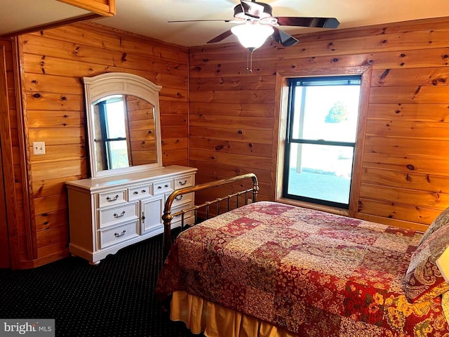 26536 Pennfields Dr, Orange, VA 22960 - bedroom with wooden walls, a ceiling fan, and dark colored carpet