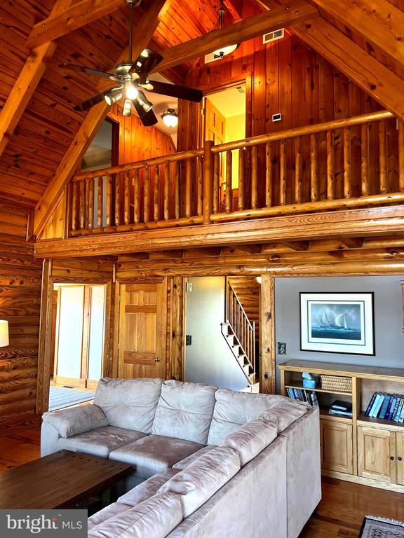 26536 Pennfields Dr, Orange, VA 22960 - living area with high vaulted ceiling, ceiling fan, beam ceiling, stairway, and wood ceiling