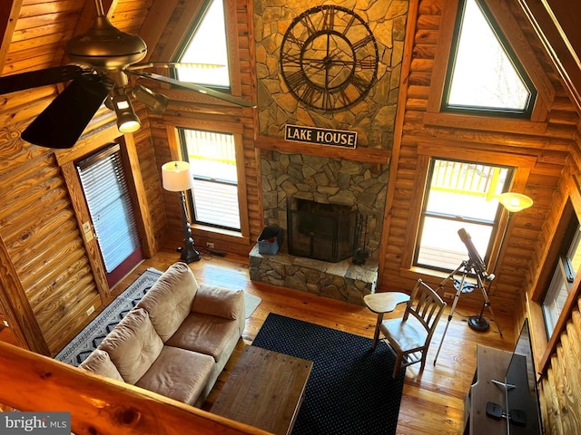 26536 Pennfields Dr, Orange, VA 22960 - living area featuring hardwood / wood-style flooring, log walls, plenty of natural light, a fireplace, and a high ceiling