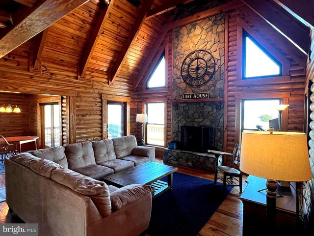 26536 Pennfields Dr, Orange, VA 22960 - living room with high vaulted ceiling, hardwood / wood-style flooring, log walls, a stone fireplace, and beamed ceiling