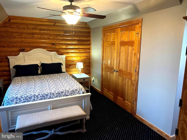 26536 Pennfields Dr, Orange, VA 22960 - bedroom with rustic walls, baseboards, dark colored carpet, ceiling fan, and a closet