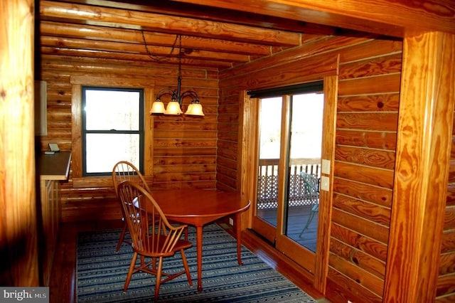 26536 Pennfields Dr, Orange, VA 22960 - dining space with rustic walls, wood finished floors, beam ceiling, and a chandelier