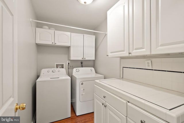6314 Foster Rd, Spotsylvania, VA 22553 - laundry area featuring cabinet space, washing machine and clothes dryer, and light wood-type flooring