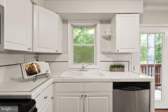 6314 Foster Rd, Spotsylvania, VA 22553 - kitchen with dishwasher, tile countertops, white cabinets, a sink, and ornamental molding