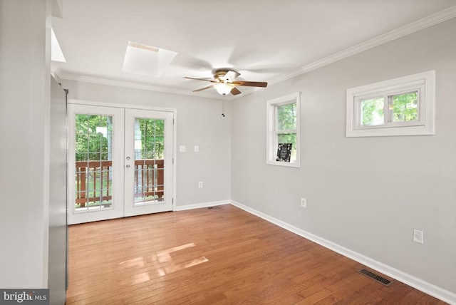 6314 Foster Rd, Spotsylvania, VA 22553 - spare room featuring french doors, a ceiling fan, wood finished floors, baseboards, and crown molding