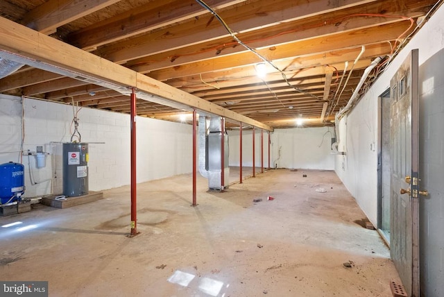 6314 Foster Rd, Spotsylvania, VA 22553 - unfinished below grade area featuring electric water heater, a water pressure tank, and heating unit