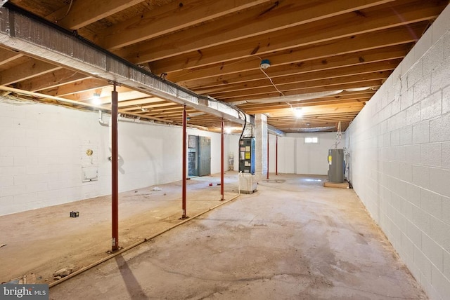 6314 Foster Rd, Spotsylvania, VA 22553 - unfinished below grade area featuring electric water heater, heating unit, and concrete block wall