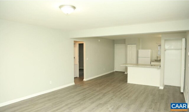 101 Westerly Ave, Charlottesville, VA 22903 - unfurnished living room featuring wood finished floors and baseboards