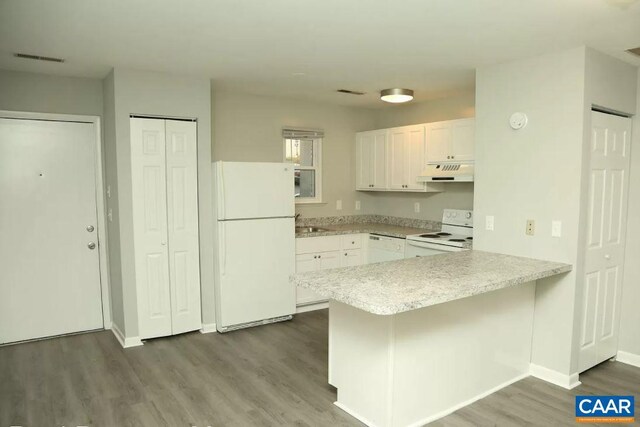 101 Westerly Ave, Charlottesville, VA 22903 - kitchen with under cabinet range hood, white appliances, a peninsula, light countertops, and white cabinets