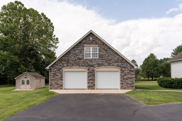 31 Hampton Dr, Stuarts Draft, VA 24477 - view of front of property with stone siding, a garage, a front lawn, and an outbuilding