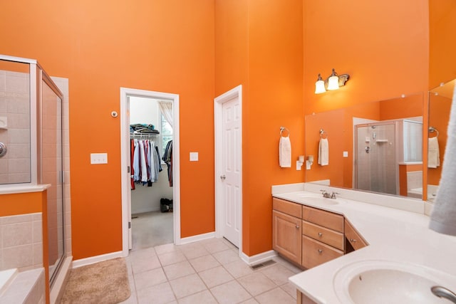 31 Hampton Dr, Stuarts Draft, VA 24477 - bathroom with a high ceiling, tile patterned flooring, a stall shower, double vanity, and a walk in closet