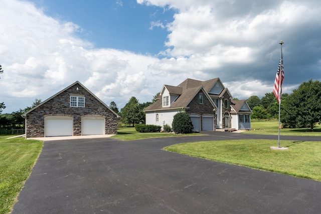 31 Hampton Dr, Stuarts Draft, VA 24477 - view of front of house with a front yard, a detached garage, and stone siding
